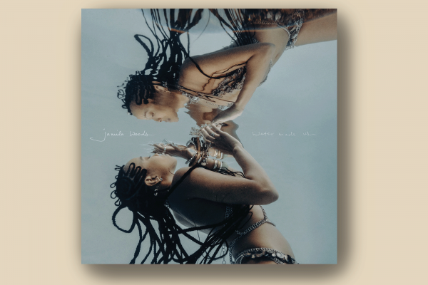 The image shows the album cover of Jamila Woods' album "Water Made Us," in which she is starring at her reflection in the water. 